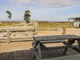 A table with a view of a fenced area and trees at 1 Small in Malton