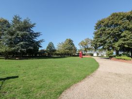 An outdoor area with trees and a telephone box at Cowshed Cottage East Knapton near Rillington