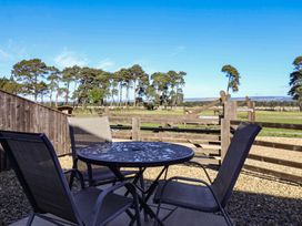 An outdoor area with a table and chairs at Cowshed Cottage in East Knapton near Rillington