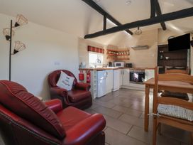 A kitchen with appliances and seating at Cowshed Cottage East Knapton near Rillington