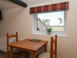 A dining room with a wooden table and chairs at Cowshed Cottage East Knapton near Rillington