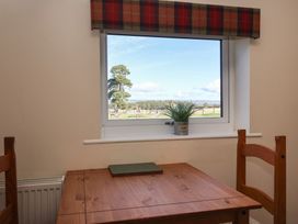 A dining room with a table and chairs at Cowshed Cottage East Knapton near Rillington