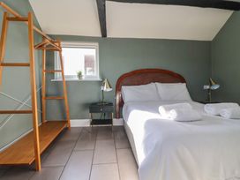 A bedroom with a bed and nightstand at Cowshed Cottage East Knapton near Rillington