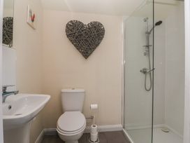 A bathroom with a shower and toilet at Cowshed Cottage East Knapton near Rillington