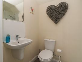A bathroom with a toilet and sink at Cowshed Cottage in East Knapton near Rillington
