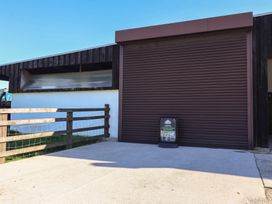 An exterior view of a building with a roller door at Cowshed Cottage East Knapton near Rillington