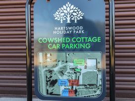 A sign showing parking information for Cowshed Cottage at Hartswood Holiday Park East Knapton near Rillington