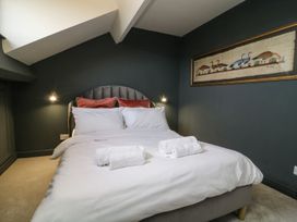 A bedroom with a bed and wall art at 2 Jade side in Malton