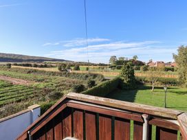 A view of fields and trees from a balcony at East Cottage East Knapton near Rillington