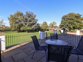 An outdoor patio area with a table and chairs at East Cottage East Knapton near Rillington