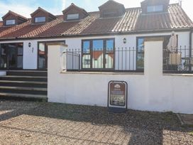 An outdoor area with a cottage, steps and a parking sign at East Cottage East Knapton near Rillington