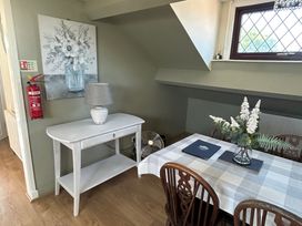 A dining room with a table and flower arrangement at West Cottage in East Knapton near Rillington