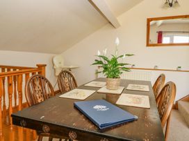A dining room with a table and chairs at 3 Marinas side in Malton