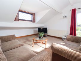 A living room with a coffee table and television at West Cottage in East Knapton near Rillington