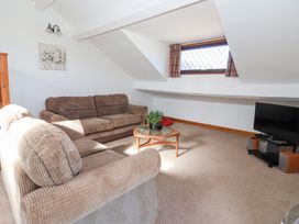 A living room with a sofa and television at West Cottage in East Knapton near Rillington