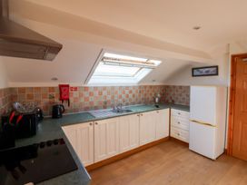 A kitchen with sink, fridge, and stove at West Cottage in East Knapton near Rillington