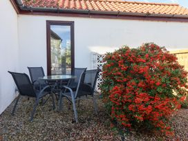 An outdoor seating area with a glass table and chairs at West Cottage East Knapton near Rillington