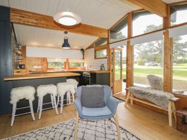 A kitchen with bar stools and a countertop at Blue Pine Lodge in Dornoch