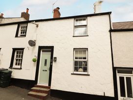 An exterior view of a house with a green door and windows at 8 Watkin Street, Conwy