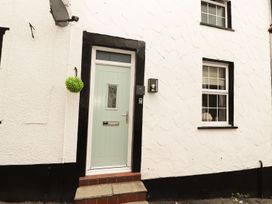 An entrance with a green door and windows at 8 Watkin Street, Conwy