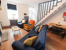 A living room with two sofas and a coffee table at 8 Watkin Street in Conwy