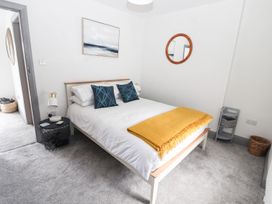 A bedroom with a bed and artwork on the wall at 8 Watkin Street in Conwy