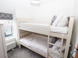 A bedroom with a bunk bed and a radiator at 8 Watkin Street Conwy