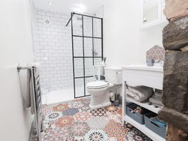 A bathroom with shower, toilet, and sink at 8 Watkin Street in Conwy