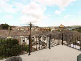 A view from a balcony overlooking rooftops and hills at 8 Watkin Street, Conwy