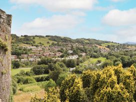 A view of houses and hills under a cloudy sky at 8 Watkin Street Conwy