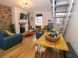 A living room with a sofa and table at 8 Watkin Street in Conwy