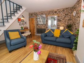 A living room with a sofa and armchairs at 8 Watkin Street in Conwy