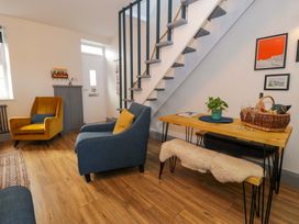 A living room with armchairs and a table at 8 Watkin Street, Conwy