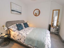 A bedroom with a bed and nightstand at 8 Watkin Street, Conwy