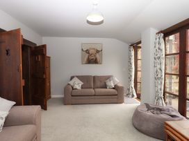 A living room with a sofa and a bean bag at The Milking Shippon at Thorne in Langtree near Great Torrington