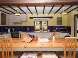 A kitchen with a dining table and appliances at The Milking Shippon at Thorne near Great Torrington