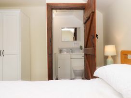 A bedroom with a view of a bathroom at The Milking Shippon at Thorne in Langtree near Great Torrington