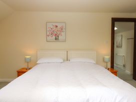A bedroom with a bed and bedside tables at The Milking Shippon at Thorne Langtree near Great Torrington