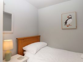 A bedroom with bed and a lamp at The Milking Shippon at Thorne Langtree near Great Torrington