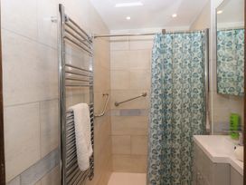 A bathroom with a shower and towel rail at The Milking Shippon at Thorne in Langtree near Great Torrington