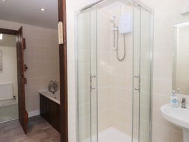 A bathroom with a shower, sink, and bathtub at The Milking Shippon at Thorne Langtree near Great Torrington