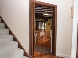 A doorway leading to a dining room with a table and chairs at The Milking Shippon at Thorne near Great Torrington
