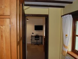 A study area with a desk and chair at The Milking Shippon at Thorne near Great Torrington