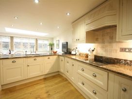 A kitchen with cabinets and a countertop at The Coach House in Burford