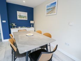 A dining room featuring a table and chairs with decor at 2 Lon Y Dryw in Trearddur Bay