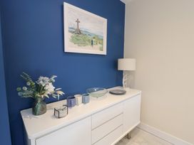 A display cabinet with a lamp and vases at 2 Lon Y Dryw Trearddur Bay