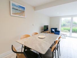 A dining room with a table and chairs at 2 Lon Y Dryw in Trearddur Bay