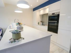 A kitchen with a sink and oven at 2 Lon Y Dryw in Trearddur Bay