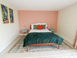 A bedroom with a bed and nightstands at 2 Lon Y Dryw Trearddur Bay