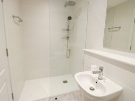 A bathroom with a shower and sink at 2 Lon Y Dryw in Trearddur Bay